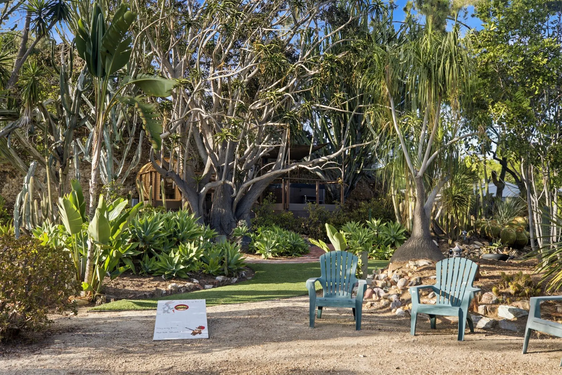 Lawn games and Adirondack chairs under the old trees