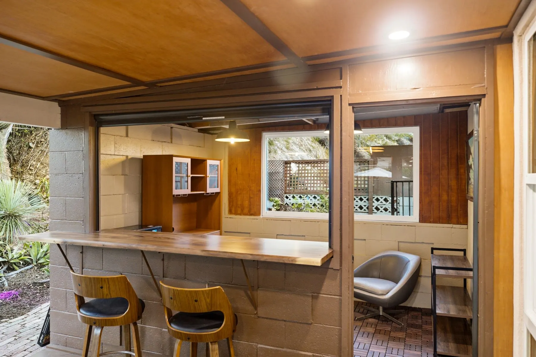 Covered outdoor room with its own bar and seating