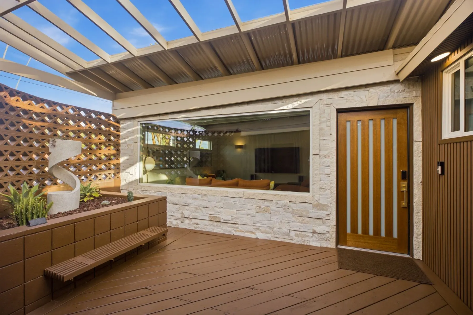 Private entry courtyard with a fountain and built-in bench