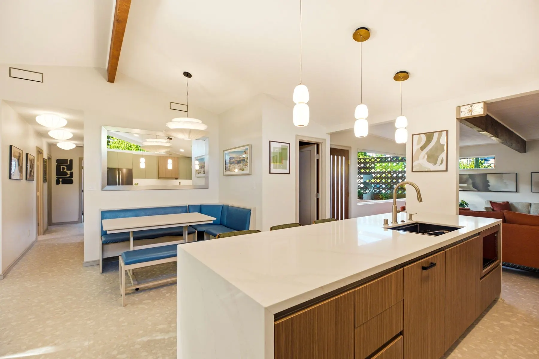 The island opens onto the built-in quartz breakfast nook