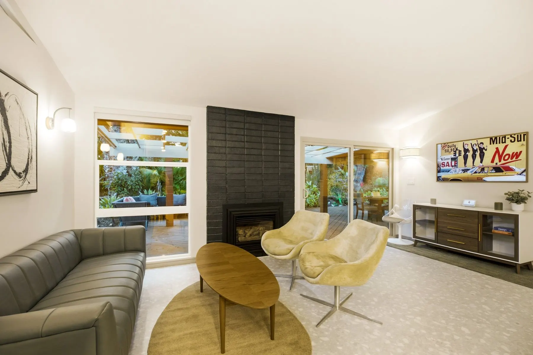 Swivel chairs by the fireplace, with garden views out both windows